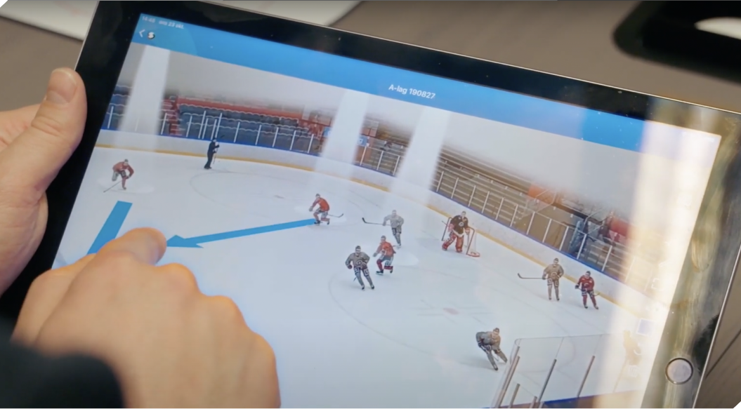 A panoramic view of an ice hockey rink and end goals